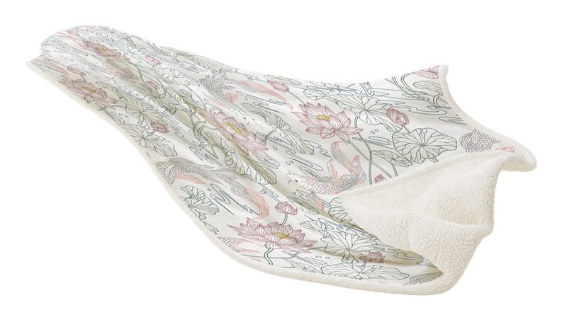 Japanica sherpa fleece blanket lifted at one end, showing the koi and lotus print on the face and the ivory sherpa reverse curling underneath