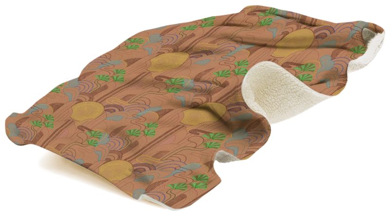 Shogo sherpa fleece blanket lifted and rippling, showing the terracotta print of golden rings, arches and green fan-shaped leaves, with the ivory sherpa reverse curling over at one end